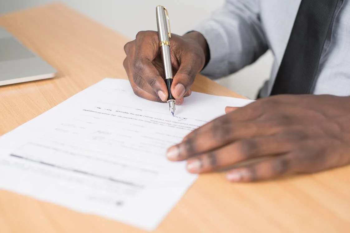 A person signing a document notarization